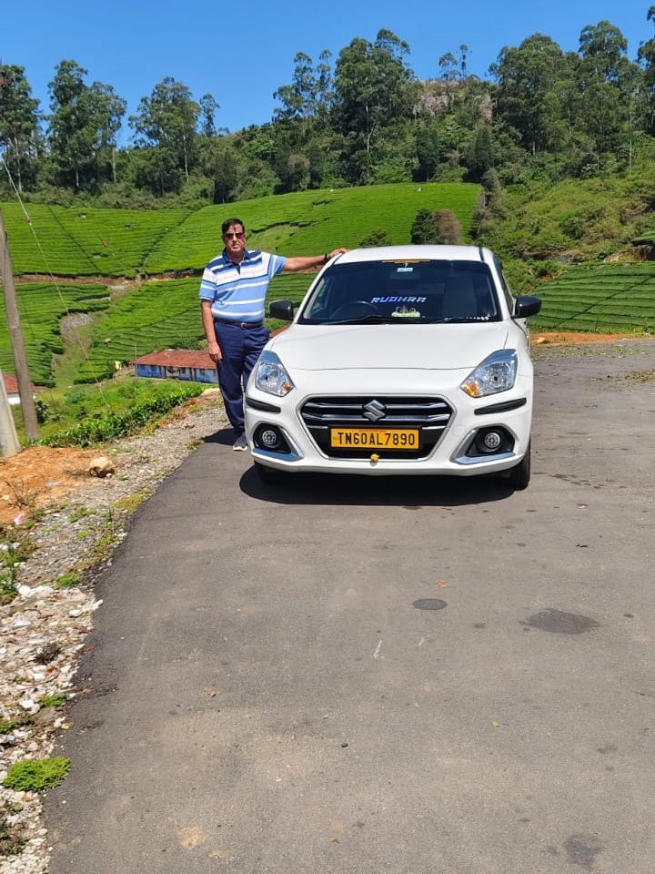 Traveller at tea estates on a hill station tour with Sri Kamatchi Amman Travels Swift Dzire